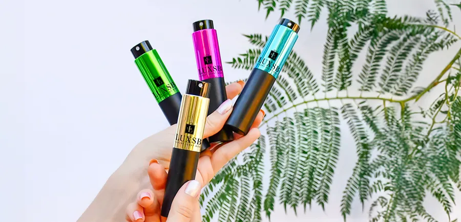 Hands holding atomizers